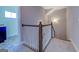 Carpeted staircase features white wood spindles and dark wood trim leading to the upper level at 509 Cowpens Rd, Social Circle, GA 30025