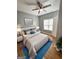Tastefully decorated bedroom with hardwood floors, ceiling fan, and a blue accent rug at 530 Shadowmoore Dr, Riverdale, GA 30274