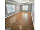 A spacious bedroom with plenty of natural light from large windows and wood flooring at 530 Shadowmoore Dr, Riverdale, GA 30274