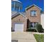 Charming brick two-story home featuring an attached garage and well-maintained landscaping at 530 Shadowmoore Dr, Riverdale, GA 30274