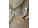 Bright living room features high ceilings, fireplace, staircase, and tile flooring at 530 Shadowmoore Dr, Riverdale, GA 30274
