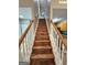 A staircase with wood steps and white railings connects floors at 530 Shadowmoore Dr, Riverdale, GA 30274