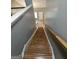 A staircase featuring wood steps and white railings at 530 Shadowmoore Dr, Riverdale, GA 30274