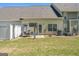 Spacious backyard featuring a patio with outdoor seating and a well-manicured lawn at 949 Pike Forest Dr, Lawrenceville, GA 30045
