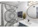 Stylish bathroom with a marble vanity, modern fixtures, and decorative shower curtain at 949 Pike Forest Dr, Lawrenceville, GA 30045