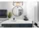 Updated bathroom featuring a marble vanity, modern fixtures, and a round mirror at 949 Pike Forest Dr, Lawrenceville, GA 30045