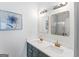 Stylish bathroom with a dual sink vanity, modern fixtures, and decorative mirrors at 949 Pike Forest Dr, Lawrenceville, GA 30045