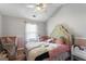Charming bedroom with a decorative bed and natural light streaming in at 949 Pike Forest Dr, Lawrenceville, GA 30045