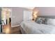 Comfortable bedroom with neutral walls, a large bed, and hardwood floors at 949 Pike Forest Dr, Lawrenceville, GA 30045