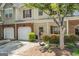 Charming townhome with attached garage and inviting front entrance with landscaped garden at 949 Pike Forest Dr, Lawrenceville, GA 30045