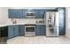 Bright kitchen featuring stainless steel appliances, shaker cabinets, and spacious countertops at 949 Pike Forest Dr, Lawrenceville, GA 30045