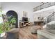 Open living room with a black arch decor, hardwood floors, and view to the kitchen at 949 Pike Forest Dr, Lawrenceville, GA 30045