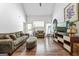 Bright living room with hardwood floors, modern entertainment center, and comfortable seating at 949 Pike Forest Dr, Lawrenceville, GA 30045