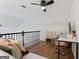 Upstairs loft featuring a ceiling fan, comfortable seating area, and designated workspace at 949 Pike Forest Dr, Lawrenceville, GA 30045