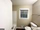 Bathroom with a window over the tub and modern fixtures and finishes at 1809 Mornington Ln, Snellville, GA 30078