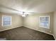 Bright bedroom featuring a ceiling fan and two windows with blinds at 1809 Mornington Ln, Snellville, GA 30078