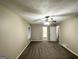 Carpeted bedroom with a ceiling fan and connections to the hallway and bathroom at 1809 Mornington Ln, Snellville, GA 30078