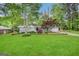 Charming single-story home with a well-manicured lawn and mature trees at 1809 Mornington Ln, Snellville, GA 30078