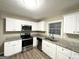 Well-lit kitchen featuring modern appliances, sleek countertops, and ample cabinet space at 1809 Mornington Ln, Snellville, GA 30078