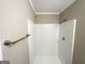 Bright shower featuring white tile and a chrome shower head and towel bar at 1809 Mornington Ln, Snellville, GA 30078