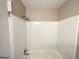 Shower featuring white tile and chrome fixtures at 1809 Mornington Ln, Snellville, GA 30078