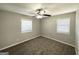 Neutral bedroom featuring ceiling fan, carpeted floors, and natural light, ready for personal touches at 2566 Nw Santa Barbara Dr, Atlanta, GA 30318