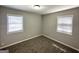 A carpeted bedroom with two windows offering natural light and neutral wall color at 2566 Nw Santa Barbara Dr, Atlanta, GA 30318