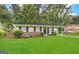 Charming single-story home with a well-manicured lawn, mature trees, and cozy carport at 2566 Nw Santa Barbara Dr, Atlanta, GA 30318