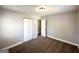 Carpeted bedroom with window, neutral walls, closet, and white door at 3566 Fairlane Nw Dr, Atlanta, GA 30331