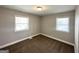 Bright, carpeted bedroom with two windows, neutral walls, and minimal design at 3566 Fairlane Nw Dr, Atlanta, GA 30331