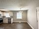 Bright kitchen and dining area featuring granite countertops and modern appliances at 3566 Fairlane Nw Dr, Atlanta, GA 30331