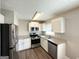 Updated kitchen featuring stainless steel appliances, granite countertops, and white cabinets at 3566 Fairlane Nw Dr, Atlanta, GA 30331
