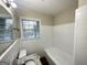 Bathroom with white tile, granite countertop, and modern fixtures at 518 Hammett Dr, Decatur, GA 30032