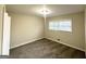 Bedroom with neutral walls, carpet, and a window that allows for ample natural light at 518 Hammett Dr, Decatur, GA 30032