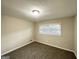 This carpeted bedroom features neutral walls and a bright window for natural light at 518 Hammett Dr, Decatur, GA 30032