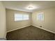 Cozy bedroom featuring neutral walls, carpeted flooring, and natural light from two windows at 518 Hammett Dr, Decatur, GA 30032