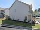 Charming townhome with lush green lawn, tidy landscaping, and ample parking for residents and visitors alike at 7703 Fawn Cir, Covington, GA 30014