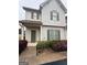 Inviting townhouse featuring classic siding, complemented by charming landscaping at 7703 Fawn Cir, Covington, GA 30014