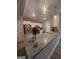Well-lit kitchen with granite countertops, stainless steel appliances, and modern pendant lights at 7703 Fawn Cir, Covington, GA 30014