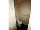 Small half-bathroom with white fixtures and wallpaper at 8023 Creekstone Way, Riverdale, GA 30274