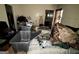Cluttered bedroom with an ironing board and an unmade bed at 8023 Creekstone Way, Riverdale, GA 30274