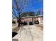 Brick townhouse complex with a gray concrete driveway and sparse winter landscaping at 8023 Creekstone Way, Riverdale, GA 30274