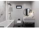 Contemporary bathroom featuring a large tub, dual sink, round mirror and modern fixtures at 2704 Antioch Ne St, Conyers, GA 30013