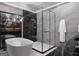 Bright bathroom featuring a standalone tub, glass enclosed shower, modern lighting, and luxury finishes at 2704 Antioch Ne St, Conyers, GA 30013