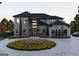 Stunning two-story home with gray brick exterior and circular landscaped driveway at 2704 Antioch Ne St, Conyers, GA 30013