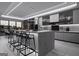 Bright modern kitchen featuring a waterfall island, stainless steel appliances, and grey cabinets at 2704 Antioch Ne St, Conyers, GA 30013