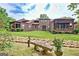 Spacious backyard with green lawn, stone bench, and manicured landscaping at 4 & 5 Northlake Cir, Peachtree City, GA 30269