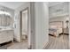 Charming bathroom and bedroom with neutral walls, round mirror, and hardwood flooring at 4 & 5 Northlake Cir, Peachtree City, GA 30269