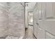 Modern bathroom with tiled shower and adjacent open door leading to bedroom at 4 & 5 Northlake Cir, Peachtree City, GA 30269