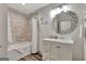Bathroom featuring a bathtub with shower, decorative round mirror, and stylish vanity at 4 & 5 Northlake Cir, Peachtree City, GA 30269